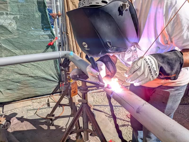 TIG welding a steel frame joint, arc lit